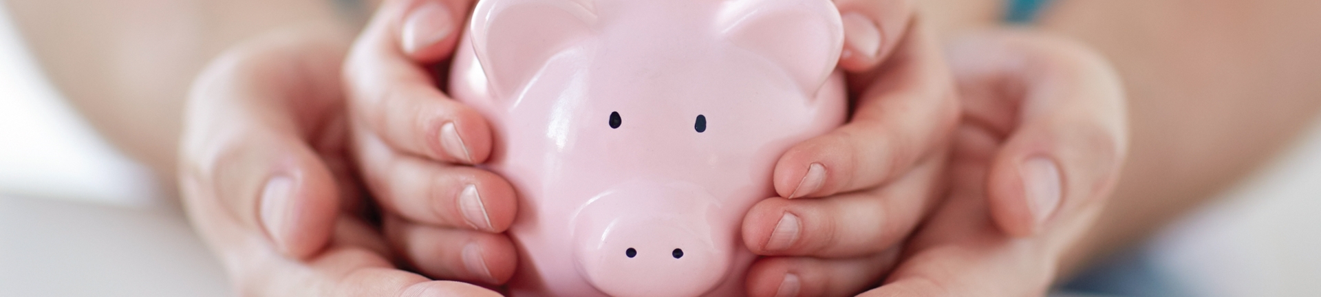 Children holding a piggy bank